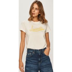 Lacoste - T-shirt. Białe bluzki damskie Lacoste, z nadrukiem, z bawełny, casualowe, z okrągłym kołnierzem. W wyprzedaży za 179,90 zł.