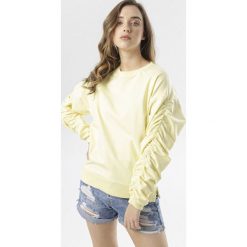 Żółta Bluza Phrigenia. Żółte bluzy damskie Born2be, xl, bez wzorów, bez rękawów, bez kaptura. W wyprzedaży za 54,99 zł.