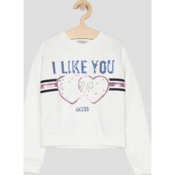 Guess Jeans - Bluza 118 - 175 cm. Białe bluzy dziewczęce Guess Jeans, z aplikacjami, z elastanu, bez rękawów, bez kaptura. W wyprzedaży za 129,90 zł.