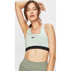 Nike - Biustonosz sportowy. Zielone biustonosze sportowe damskie Nike, xs, z nadrukiem, z elastanu, dri-fit (nike). W wyprzedaży za 119,90 zł.