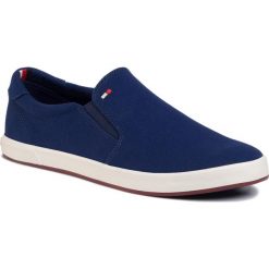 Tenisówki TOMMY HILFIGER - Iconic Slip On Sneaker FM0FM00597 Blue Ink C7H. Niebieskie półbuty męskie TOMMY HILFIGER, na co dzień, bez wzorów, z gumy, eleganckie, bez zapięcia. Za 269,00 zł.