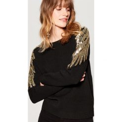 Sweter z cekinową aplikacją - Czarny. Czarne swetry klasyczne damskie Mohito, l. Za 119,99 zł.