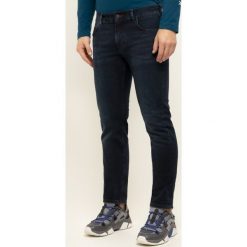 Jeansy Slim Fit TOMMY HILFIGER Dentron Str Burke MW0MW12663. Niebieskie spodnie męskie TOMMY HILFIGER, m, bez wzorów, z elastanu. W wyprzedaży za 299,00 zł.
