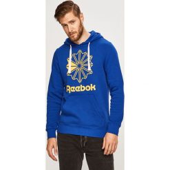 Reebok Classic - Bluza. Niebieskie bluzy męskie s, z nadrukiem, z elastanu, z kapturem. W wyprzedaży za 159,90 zł.