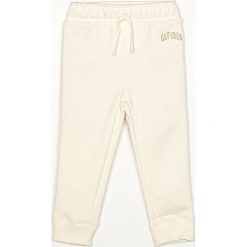 GAP - Spodnie dziecięce 80-104 cm. Białe spodnie dziewczęce GAP, bez wzorów, z bawełny. Za 99,90 zł.