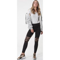Czarne Legginsy Assis. Czarne legginsy sportowe damskie Born2be, s, z aplikacjami, z dzianiny. Za 79,99 zł.