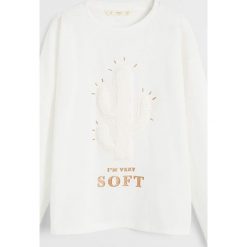 Mango Kids - Longsleeve dziecięcy Soft110-164 cm. Białe bluzki dziewczęce Mango Kids, z nadrukiem, z bawełny, z okrągłym kołnierzem, z krótkim rękawem, krótkie, bez kaptura. Za 59,90 zł.