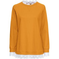 Bluza oversize z koronką bonprix miodowy. Pomarańczowe bluzy damskie bonprix, w koronkowe wzory, z koronki, bez rękawów, bez kaptura. Za 109,99 zł.