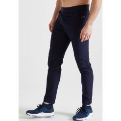 Spodnie fitness cardio FPA 500 męskie. Niebieskie spodnie męskie DOMYOS, s, bez wzorów, z elastanu, sportowe. Za 79,99 zł.
