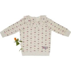 Bluza w kolorze kremowo-różowym. Różowe bluzy niemowlęce Benetton Kids, bez wzorów, bez rękawów, bez kaptura. W wyprzedaży za 39,95 zł.