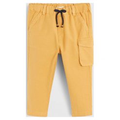Mango Kids - Spodnie dziecięce Wally 80-104. Żółte spodnie chłopięce Mango Kids, bez wzorów, z bawełny, casualowe. Za 79,90 zł.