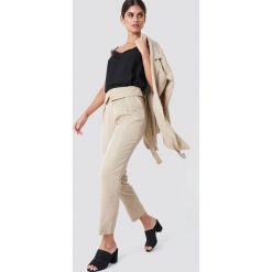 Trendyol Spodnie z wysokim stanem - Beige. Brązowe spodnie z wysokim stanem marki Trendyol, z lyocellu. Za 161,95 zł.