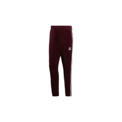 Spodnie treningowe adidas Spodnie dresowe BB. Czerwone spodnie dresowe męskie marki Adidas, m, z dresówki. Za 329,00 zł.