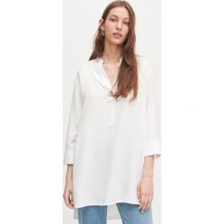 Długa bluzka oversize - Kremowy. Białe bluzki damskie Reserved, bez wzorów, bez kołnierzyka, z długim rękawem. Za 119,99 zł.