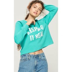 Bluza z nadrukiem - Turkusowy. Niebieskie bluzy z nadrukiem damskie Sinsay, l. W wyprzedaży za 19,99 zł.