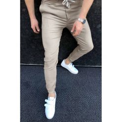Męskie spodnie CHRISTIAN BEIGE. Brązowe jeansy męskie IVET, m, bez wzorów, sportowe. W wyprzedaży za 79,00 zł.