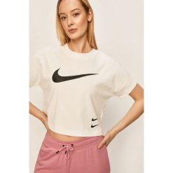 Nike Sportswear - T-shirt. Różowe topy damskie Nike Sportswear, s, z nadrukiem, z bawełny, z okrągłym kołnierzem. Za 129,90 zł.