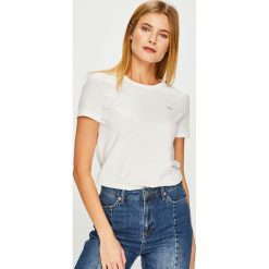 Lacoste - Top. Białe topy damskie marki Lacoste, s, z bawełny, z okrągłym kołnierzem. W wyprzedaży za 179,90 zł.