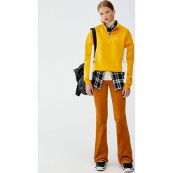Bluza z suwakiem i panelami po bokach. Białe bluzy damskie Pull&Bear, bez wzorów, bez rękawów, bez kaptura. Za 89,90 zł.