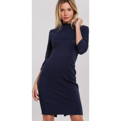 Granatowa Sukienka Feminal. Niebieskie sukienki damskie Renee, na imprezę, na wiosnę, xl, bez wzorów, z dzianiny, ze stójką, bez rękawów, mini, dopasowane. Za 109,99 zł.