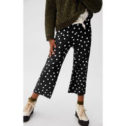 Mango Kids - Spodnie dziecięce Unido 110-164 cm. Czarne spodnie dziewczęce Mango Kids, bez wzorów, z elastanu. Za 69,90 zł.