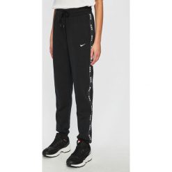 Nike Sportswear - Spodnie. Czarne spodnie damskie Nike Sportswear, s, bez wzorów, z elastanu, casualowe. Za 229,90 zł.