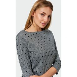 Elegancka bluzka dzianinowa. Bluzki damskie Greenpoint, bez wzorów, z elastanu, eleganckie, bez kołnierzyka, bez rękawów. Za 39,99 zł.