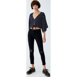Jeansy skinny fit capri ze średnim stanem. Czarne jeansy damskie Pull&Bear, z jeansu. Za 79,90 zł.