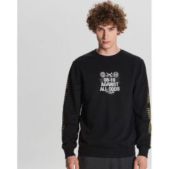 Bluza Baltic Games - Czarny. Czarne bluzy męskie Cropp, s, bez wzorów, bez kołnierzyka, bez rękawów, bez kaptura. W wyprzedaży za 49,99 zł.