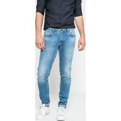Marciano Guess - Jeansy Tommy. Niebieskie jeansy męskie z dziurami marki MARCIANO GUESS. W wyprzedaży za 269,90 zł.