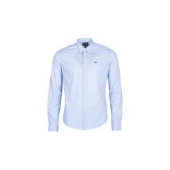 Koszule z długim rękawem Emporio Armani GEWA. Niebieskie koszule męskie marki Emporio Armani, xl, bez wzorów, bez kołnierzyka, z długim rękawem. Za 495,20 zł.