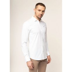 Koszula Tommy Jeans DM0DM04405. Niebieskie koszule męskie Tommy Jeans, m, bez wzorów, z elastanu, casualowe, bez kołnierzyka, bez rękawów. W wyprzedaży za 209,00 zł.