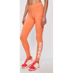 Adidas - Legginsy. Pomarańczowe spodnie damskie Adidas, s, z nadrukiem, z elastanu. W wyprzedaży za 99,90 zł.