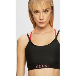 Guess Jeans - Biustonosz. Czarne biustonosze sportowe damskie Guess Jeans, xs, z aplikacjami, z elastanu. W wyprzedaży za 89,90 zł.