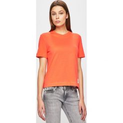 Calvin Klein Jeans - Top. Pomarańczowe bluzki damskie Calvin Klein Jeans, s, bez wzorów, z bawełny, casualowe, z okrągłym kołnierzem. W wyprzedaży za 119,90 zł.