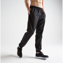 Spodnie fitness kardio FPA 120 męskie. Czarne spodnie męskie DOMYOS, s, bez wzorów, z poliesteru, klasyczne. Za 59,99 zł.