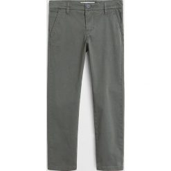 Mango Kids - Spodnie dziecięce Piccolo6 110-164 cm. Niebieskie spodnie chłopięce Mango Kids, bez wzorów, z elastanu. Za 69,90 zł.