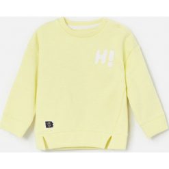 Bawełniana bluza z napisem - Żółty. Żółte bluzy męskie Reserved, m, z napisami, z bawełny, bez kołnierzyka, bez rękawów, bez kaptura. Za 35,99 zł.