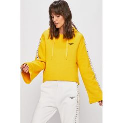 Reebok Classic - Bluza. Żółte bluzy damskie Reebok Classic, s, z aplikacjami, z bawełny, bez rękawów, z kapturem. W wyprzedaży za 199,90 zł.