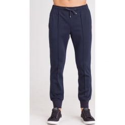 SPODNIE DRESOWE EMPORIO ARMANI. Niebieskie spodnie męskie s, z dresówki, klasyczne. Za 849,00 zł.
