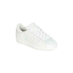Buty adidas SUPERSTAR W. Białe trampki i tenisówki damskie Adidas, bez wzorów, bez zapięcia. Za 359,20 zł.