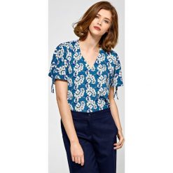 Elegancka bluzka we wzory krótki rękaw - 40. Bluzki damskie e-margeritka.pl, bez wzorów, z elastanu, eleganckie, z długim rękawem, długie, bez kaptura. Za 118,99 zł.