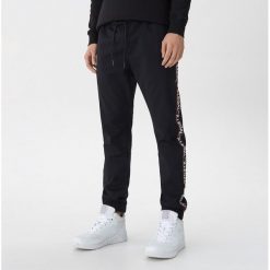 Joggery z lampasami - Czarny. Czarne spodnie męskie marki House, s, bez wzorów. Za 129,99 zł.