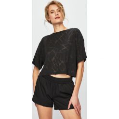 Puma - Top. Czarne topy damskie marki Puma, l, z dzianiny, z okrągłym kołnierzem. Za 159,90 zł.
