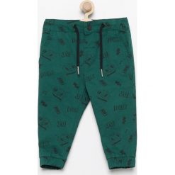 Spodnie jogger z nadrukiem - Zielony. Zielone spodnie chłopięce marki Reserved, z nadrukiem. W wyprzedaży za 29,99 zł.