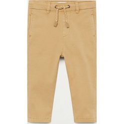 Mango Kids - Spodnie dziecięce Cord 80-104 cm. Żółte spodnie chłopięce Mango Kids, bez wzorów, z elastanu. Za 69,99 zł.