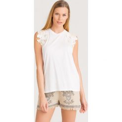 BLUZKA Twinset. Białe bluzki damskie Twinset, xs, w koronkowe wzory, z tkaniny, z okrągłym kołnierzem, bez rękawów. Za 335,00 zł.