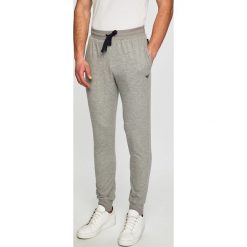 Emporio Armani - Spodnie. Niebieskie spodnie męskie Emporio Armani, na co dzień, xl, bez wzorów, z elastanu, casualowe. W wyprzedaży za 249,90 zł.