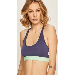 Calvin Klein Underwear - Biustonosz. Fioletowe biustonosze sportowe damskie Calvin Klein Underwear, s, bez wzorów, z elastanu. W wyprzedaży za 89,90 zł.