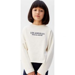 Mango Kids - Bluza dziecięca Angeles 122-164 cm. Białe bluzy dziewczęce Mango Kids, z nadrukiem, z bawełny, bez rękawów, bez kaptura. W wyprzedaży za 47,90 zł.